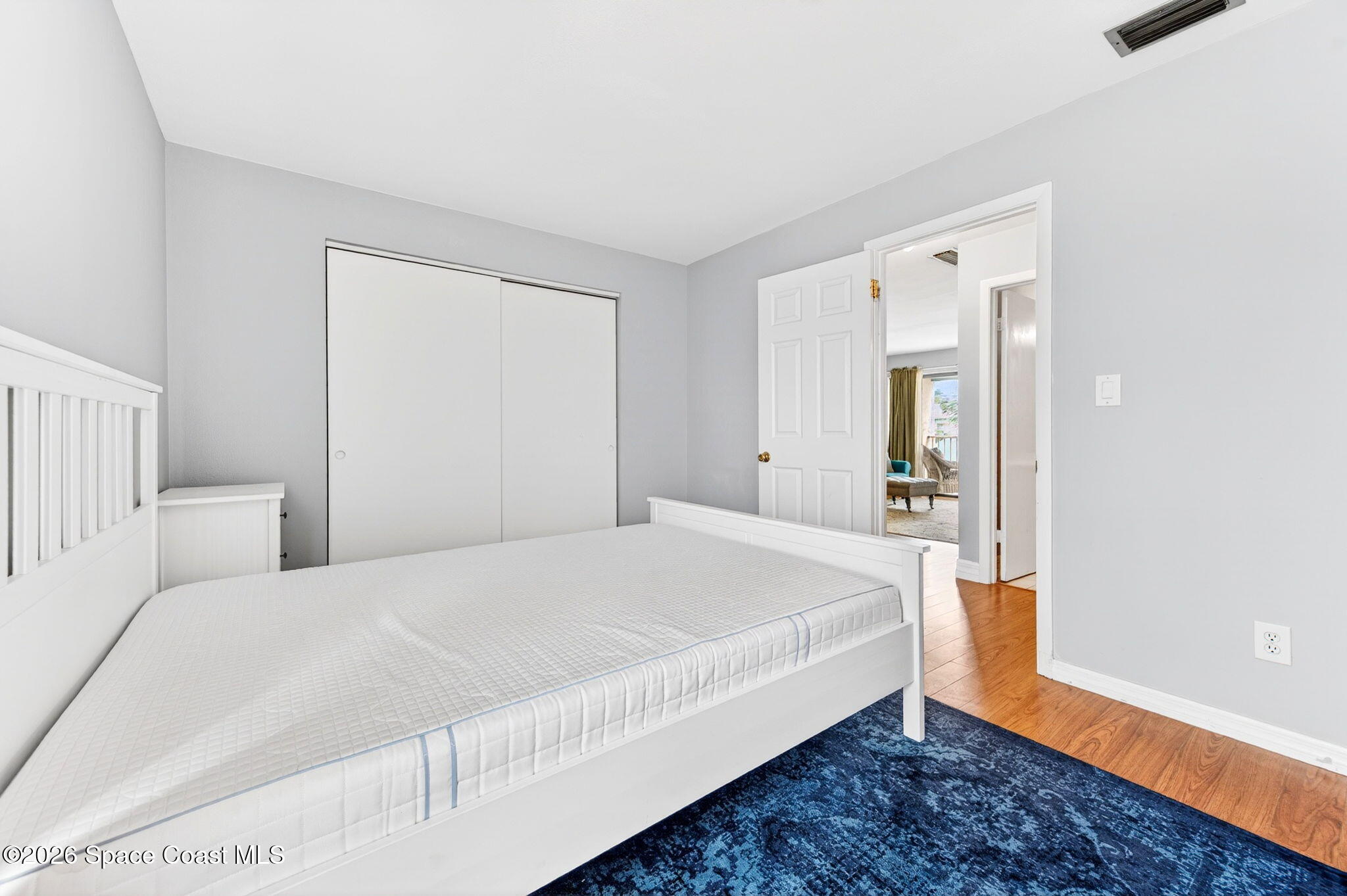 1225 North Wickham Road, Unit 422 Melbourne, FL 32935 - Photo 18 of 32 a bedroom with a bed and a mirror