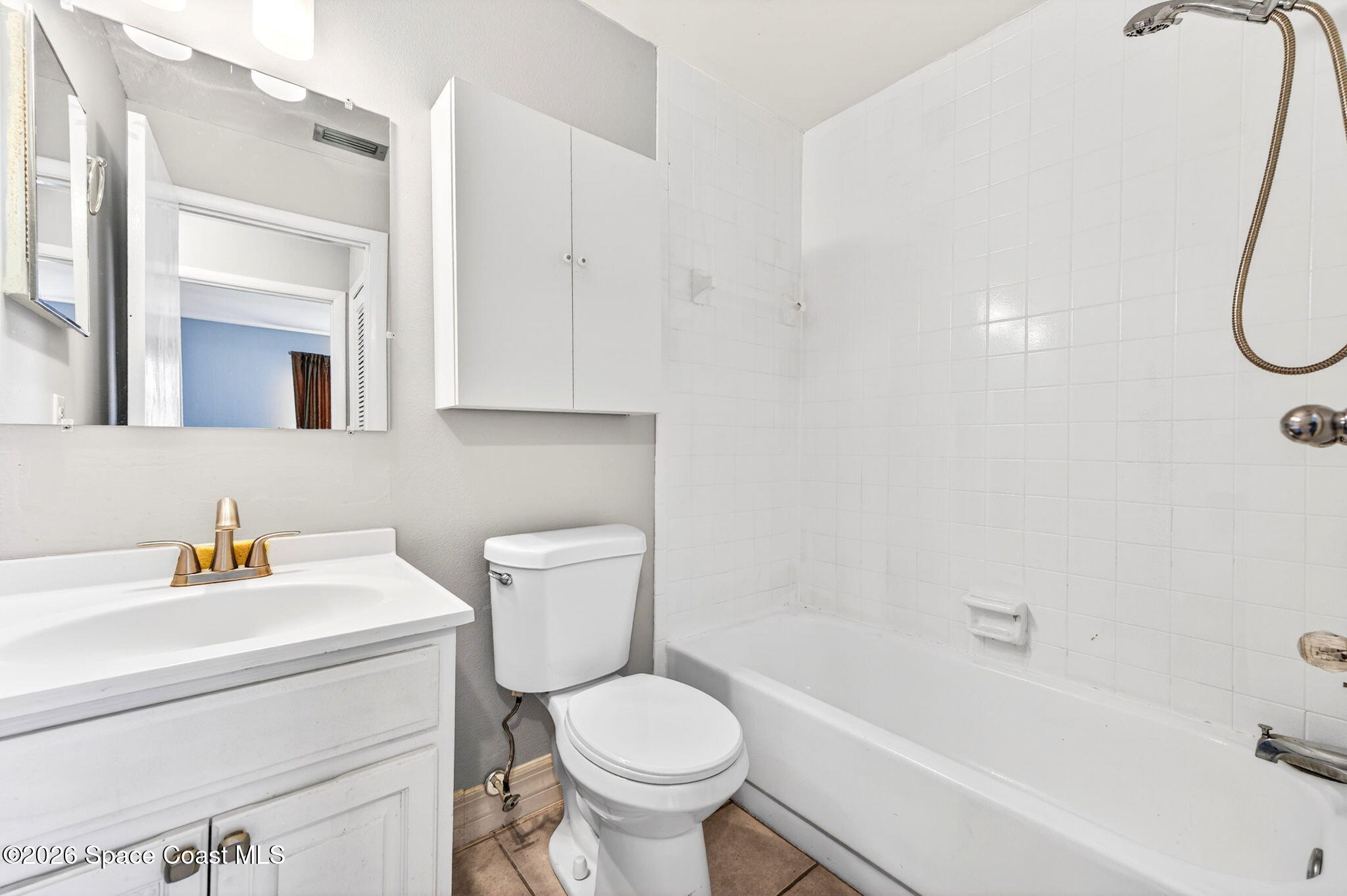 1225 North Wickham Road, Unit 422 Melbourne, FL 32935 - Photo 19 of 32 a bathroom with a sink a toilet and a bathtub