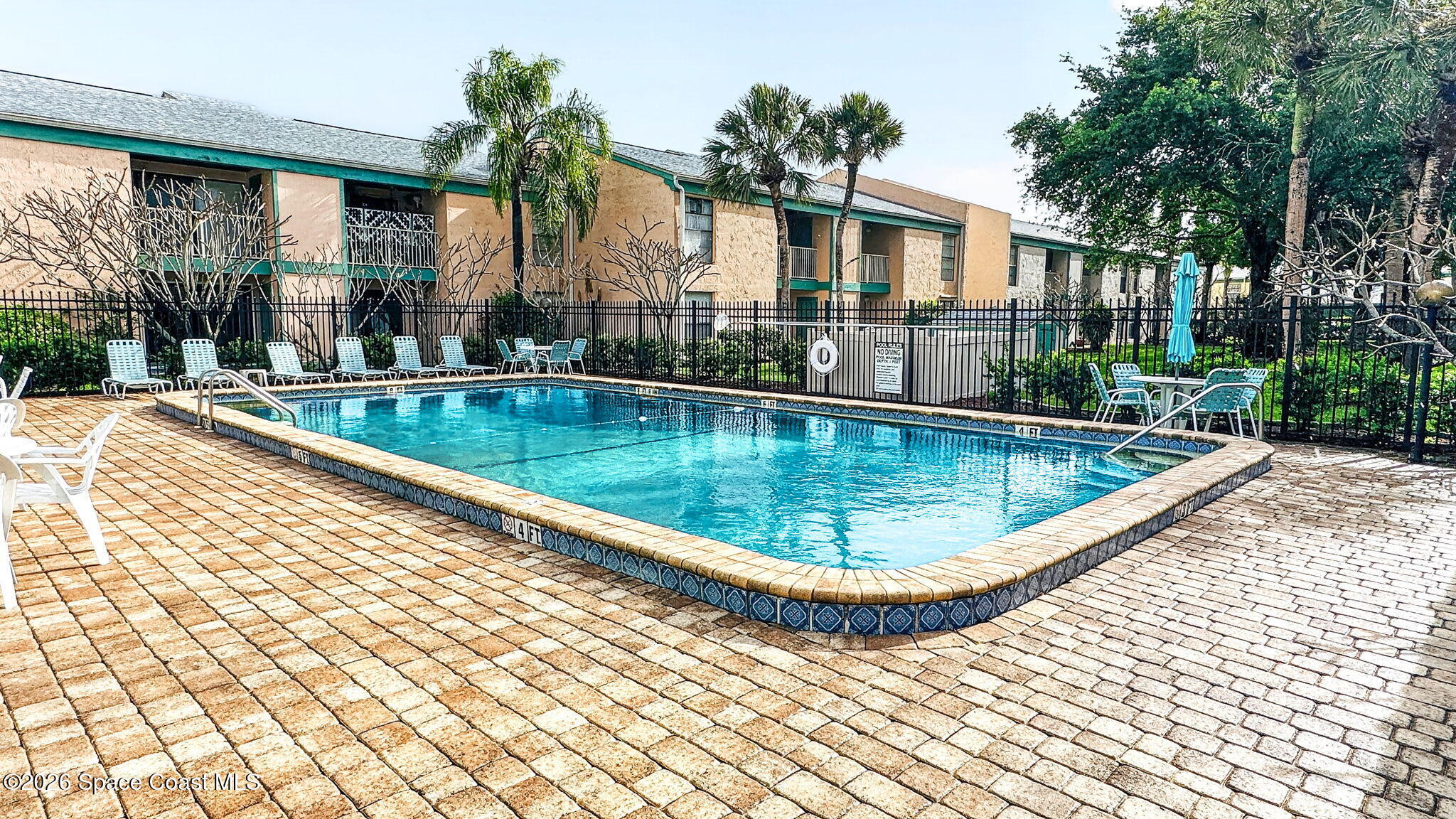 1225 North Wickham Road, Unit 422 Melbourne, FL 32935 - Photo 32 of 32 a view of swimming pool with outdoor seating