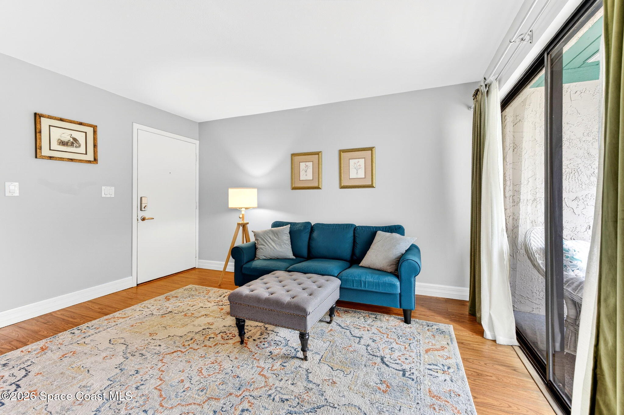 1225 North Wickham Road, Unit 422 Melbourne, FL 32935 - Photo 6 of 32 a living room with furniture and a rug
