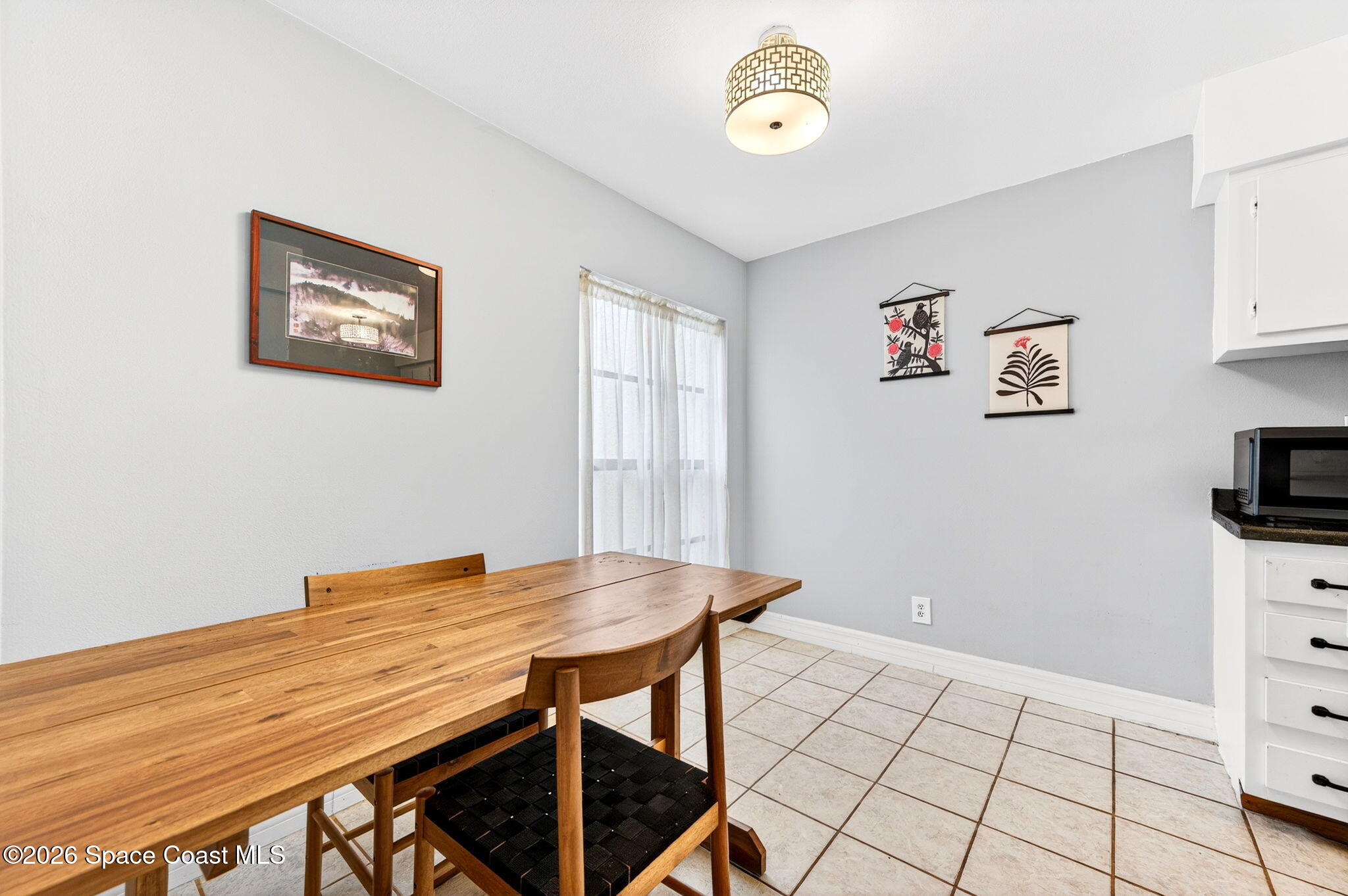1225 North Wickham Road, Unit 422 Melbourne, FL 32935 - Photo 9 of 32 a view of kitchen with furniture and wooden floor