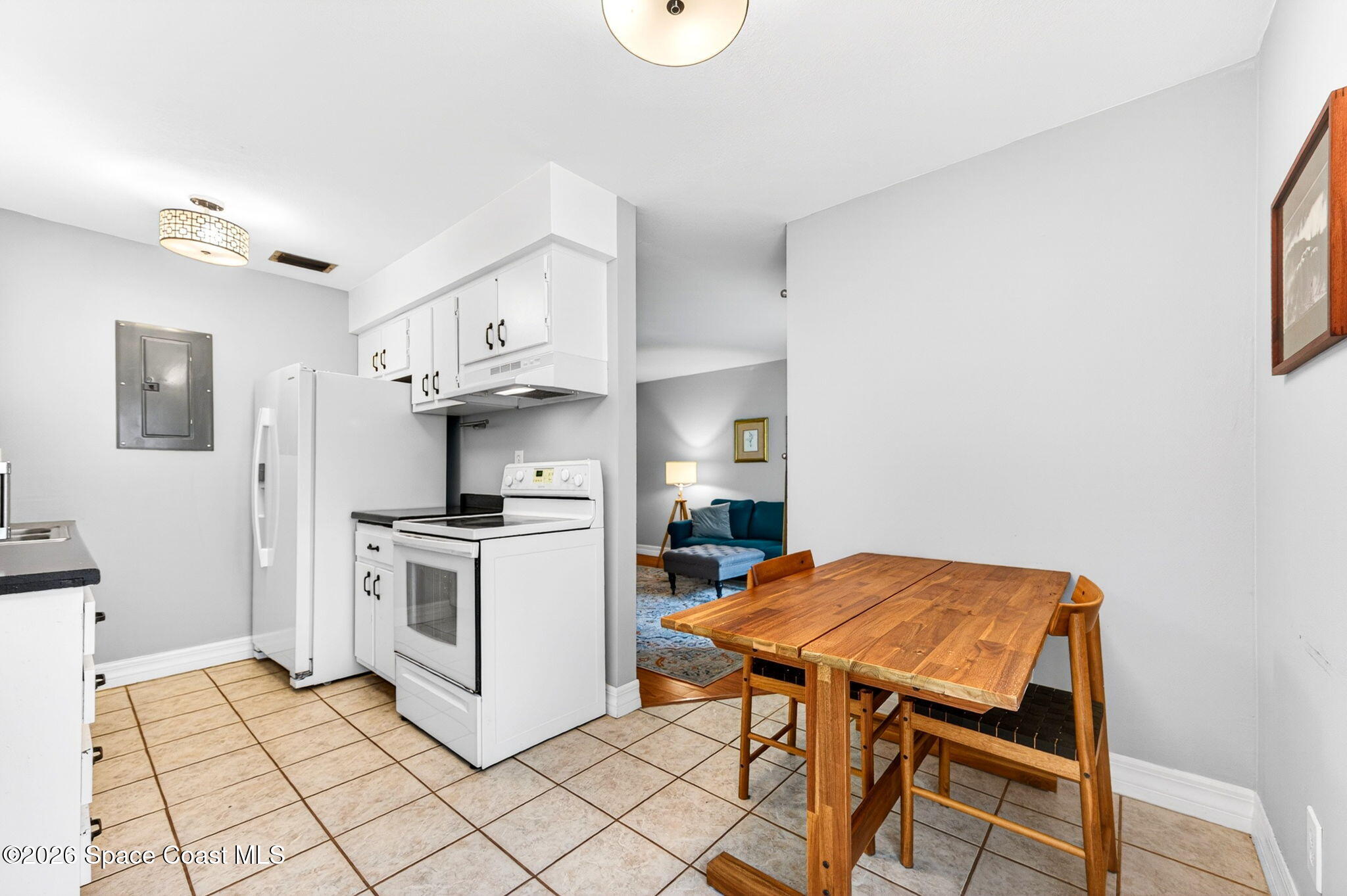 1225 North Wickham Road, Unit 422 Melbourne, FL 32935 - Photo 10 of 32 a kitchen with stainless steel appliances a stove a sink cabinets and a dining table