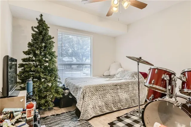 a bedroom with a bed and a chandelier