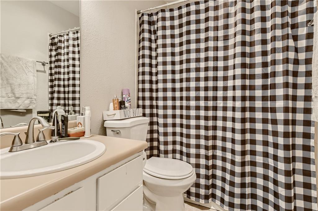 2126 Redwing Way Round Rock, TX 78664 - Photo 9 of 13 a bathroom with a sink a toilet and a mirror