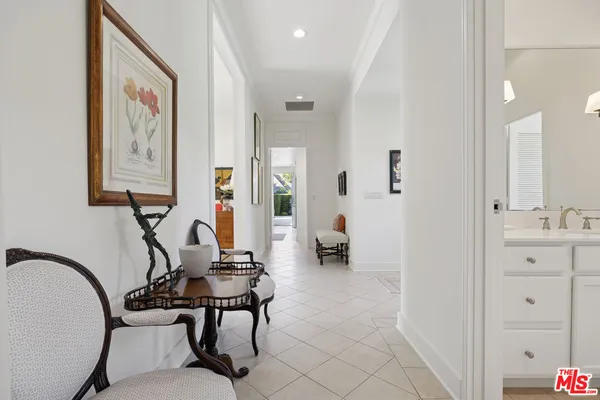 a view of a hallway with workspace and a mirror