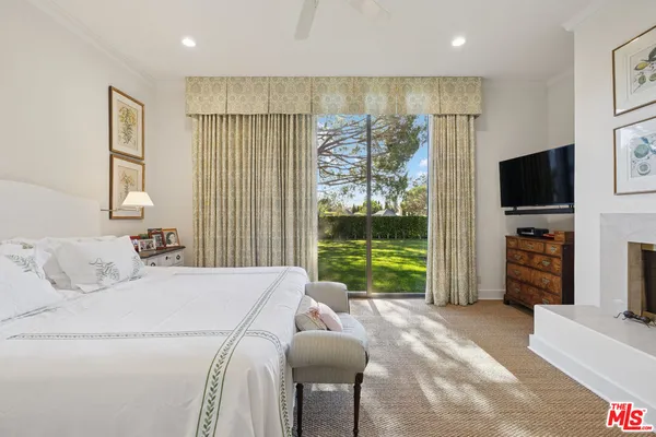 a bed room with a bed and a television