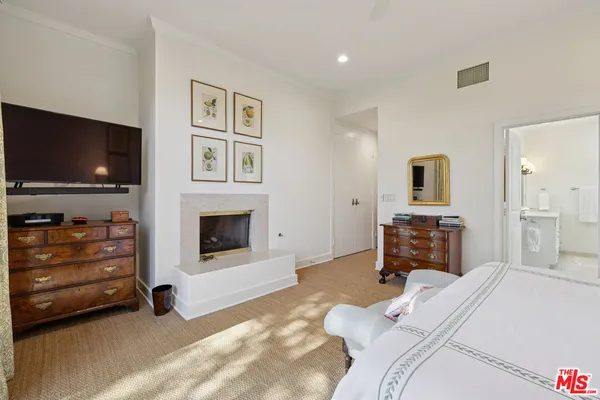 a bedroom with furniture and a flat screen tv