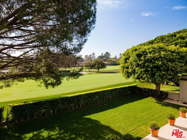 a view of a patio with couches and table and chairs and garden