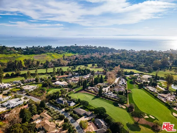 a aerial view of a house with garden space and street view