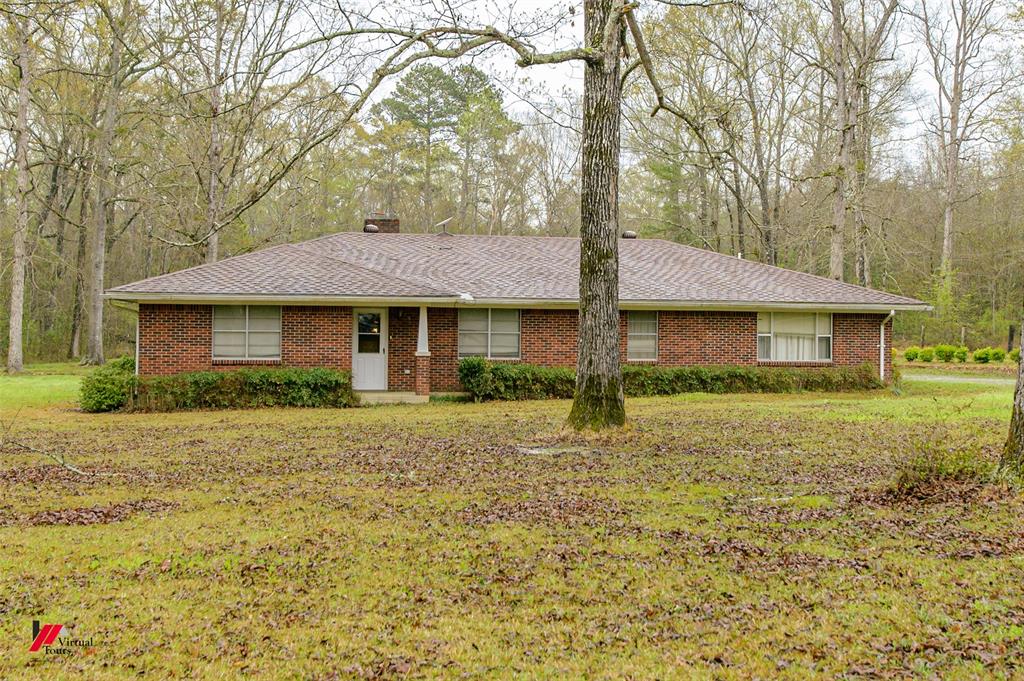 1732 King Orchard Road Sarepta, LA 71071 - Photo 2 of 40 Ranch-style house featuring brick siding, a chimney, a front lawn, and a shingled roof