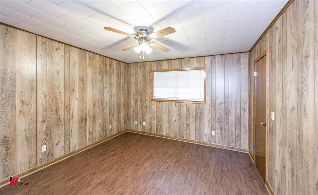 1732 King Orchard Road Sarepta, LA 71071 - Photo 21 of 40 Unfurnished room with baseboards, wood finished floors, and a ceiling fan