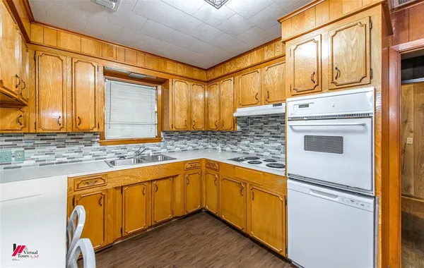 a kitchen with granite countertop wooden cabinets and a stainless steel appliances
