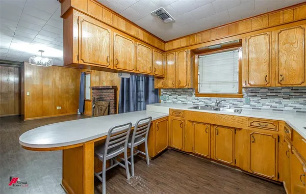 a kitchen with stainless steel appliances granite countertop a sink and cabinets