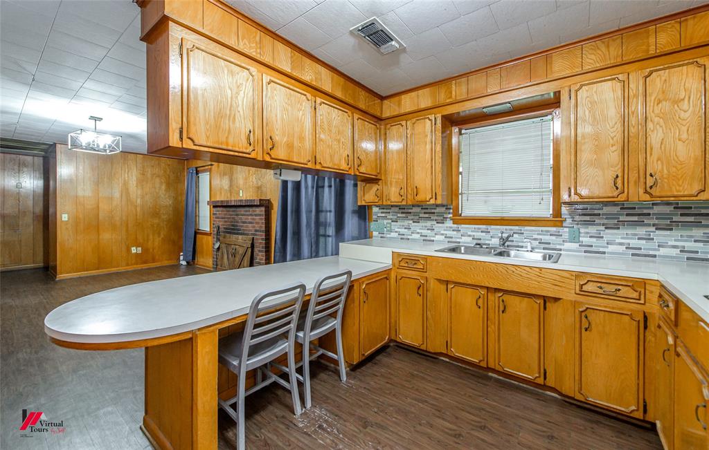 1732 King Orchard Road Sarepta, LA 71071 - Photo 28 of 40 Kitchen with decorative backsplash, visible vents, light countertops, and a sink