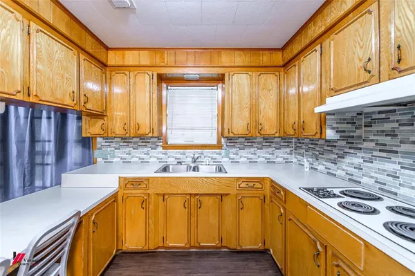 a kitchen with a stove and a sink