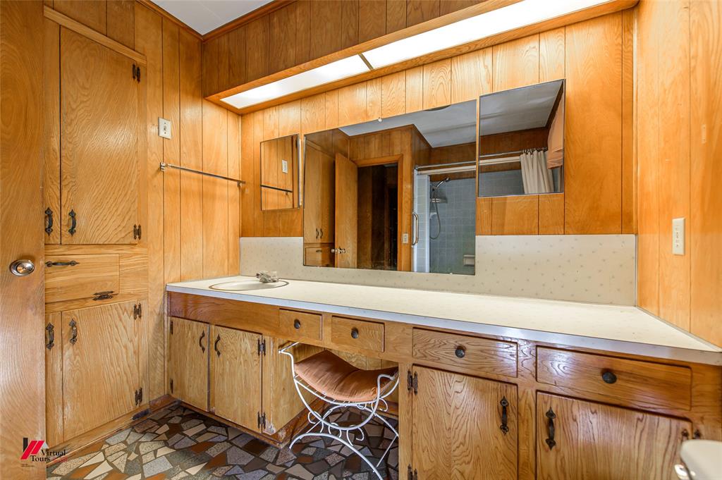 1732 King Orchard Road Sarepta, LA 71071 - Photo 32 of 40 Bathroom with vanity, a shower with door, and wood walls