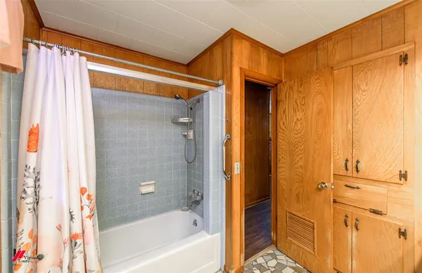 a bathroom with a bathtub and a shower