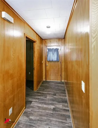 a view of hallway with wooden floor