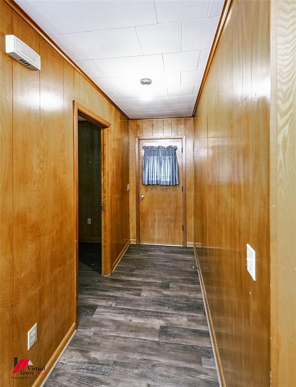 1732 King Orchard Road Sarepta, LA 71071 - Photo 35 of 40 Corridor with wood walls, ornamental molding, and dark wood-style flooring