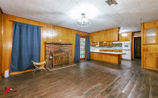 a view of a kitchen with a sink and a refrigerator