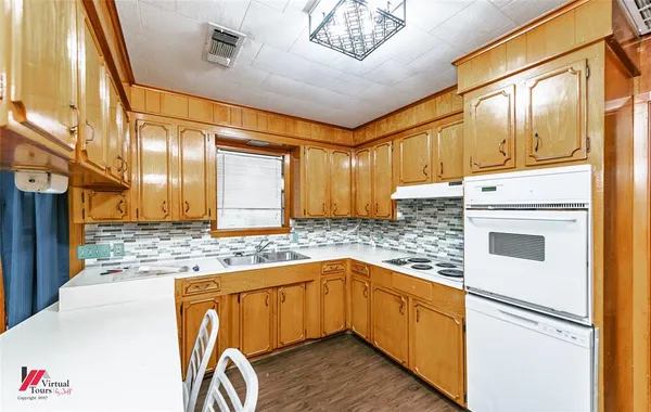 a kitchen with granite countertop a sink and cabinets