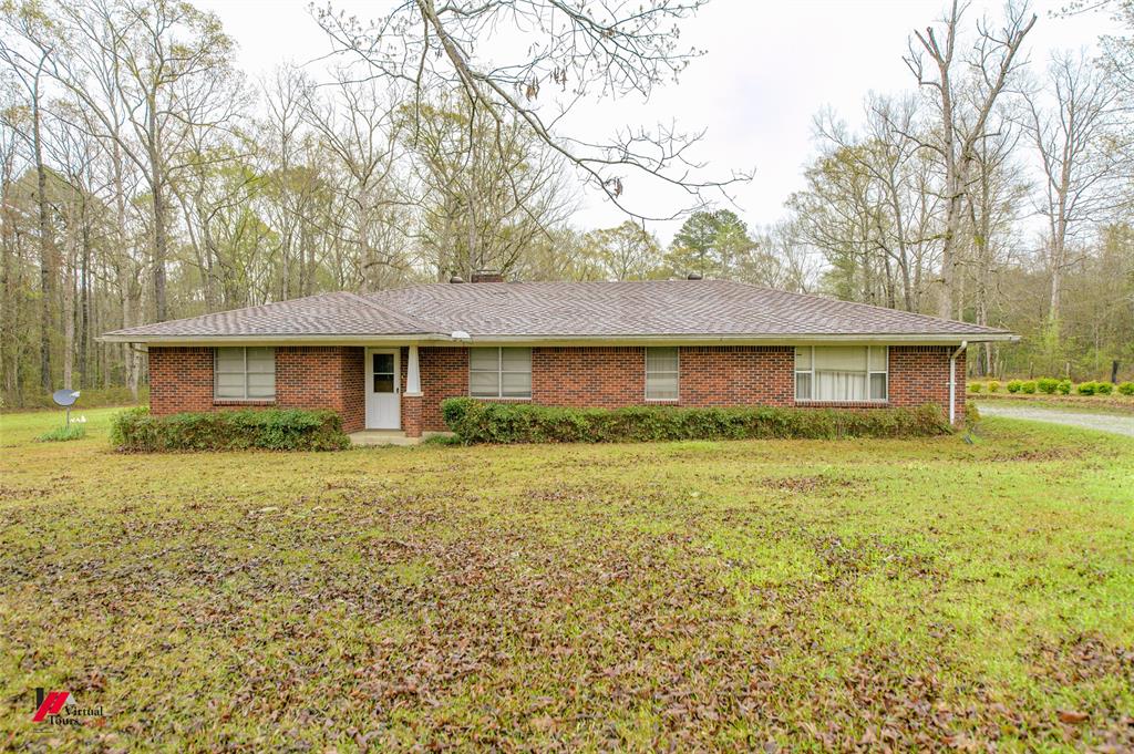 1732 King Orchard Road Sarepta, LA 71071 - Photo 4 of 40 Ranch-style home featuring brick siding, a front yard, and a chimney