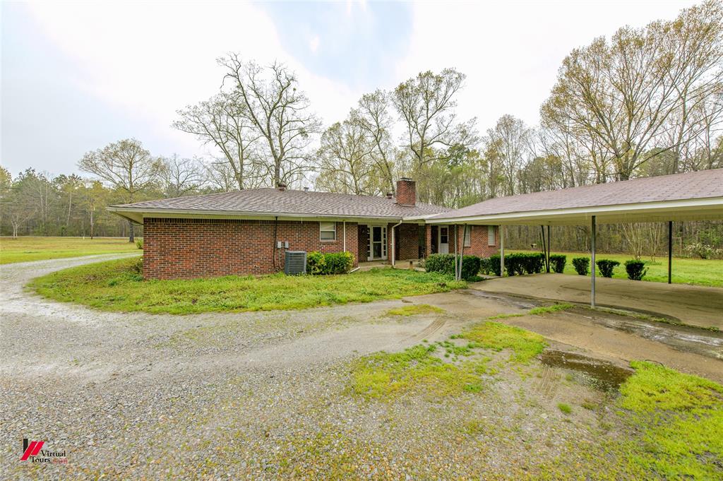 1732 King Orchard Road Sarepta, LA 71071 - Photo 6 of 40 Single story home with driveway, a chimney, cooling unit, and a front yard
