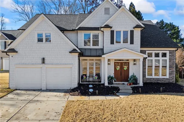 a front view of a house with a yard