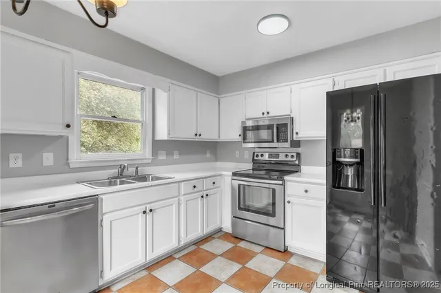 a kitchen with a sink stove and refrigerator