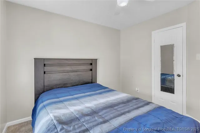 a bedroom with a bed and lamp