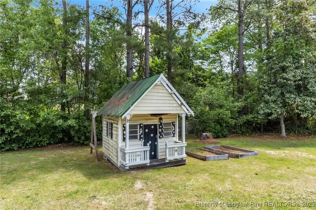 a view of a house with backyard porch and sitting area