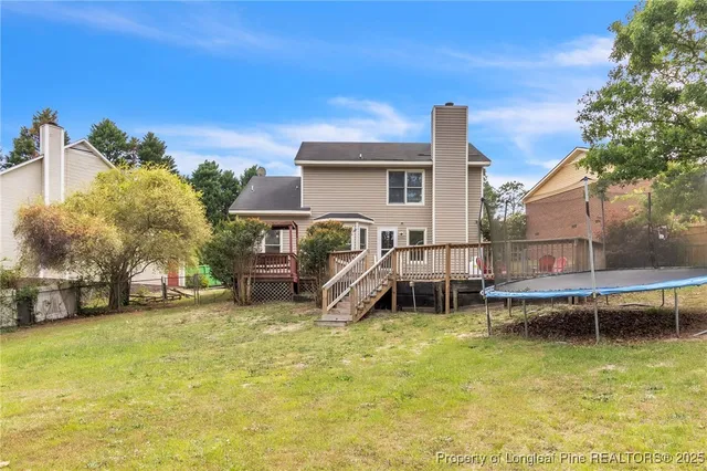 a view of a house with swimming pool and sitting area