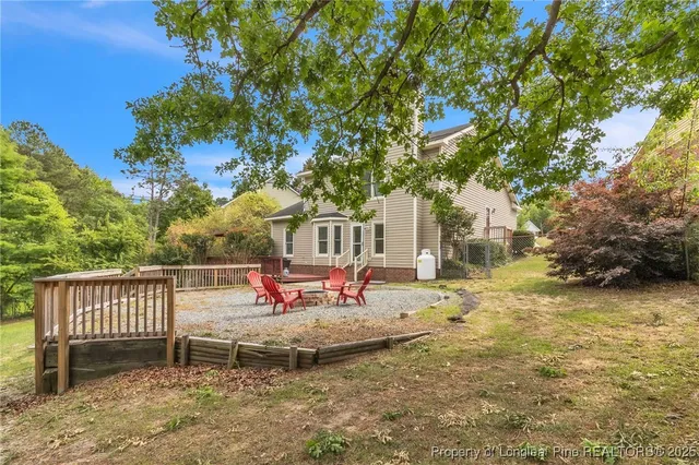a backyard of a house with table and chairs