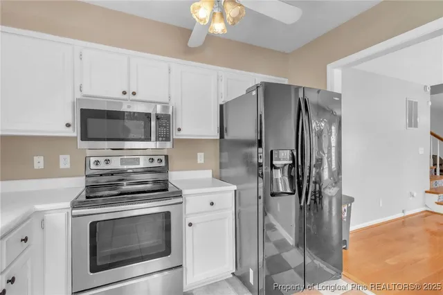 a kitchen with stainless steel appliances a stove a microwave and a refrigerator