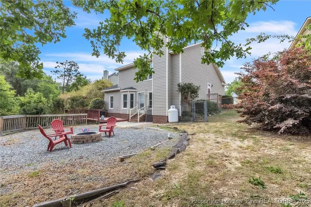 a backyard of a house with table and chairs
