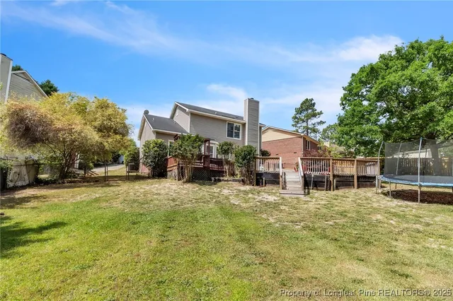 a view of a house with a yard and sitting area