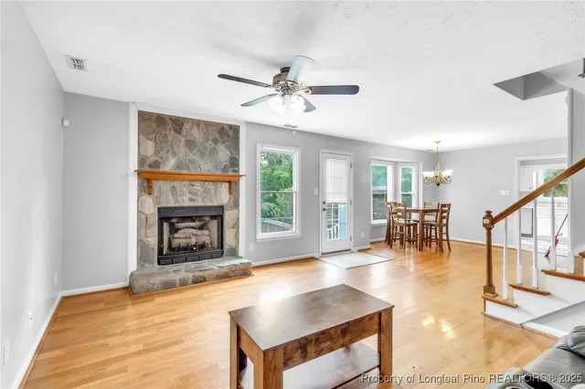 a living room with fireplace furniture and a fireplace