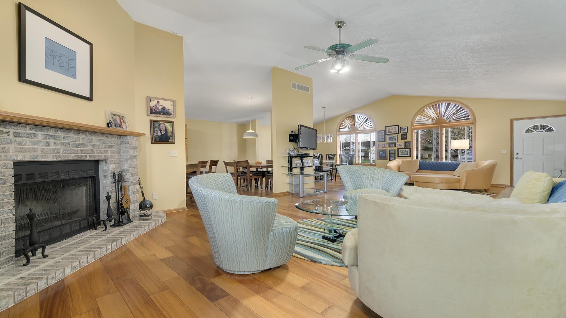 4208 Waltham Road Roscoe, IL 61073 - Photo 8 of 29 a living room with furniture a fireplace and a chandelier