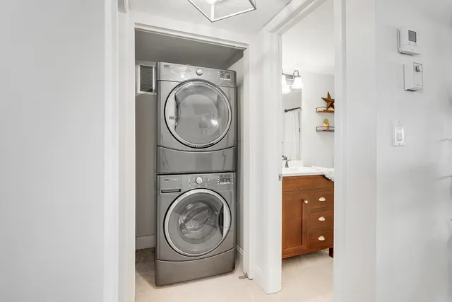 a bathroom with a granite countertop sink a toilet a shower and a mirror