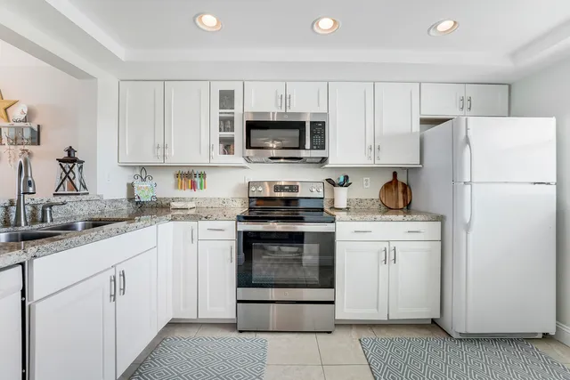 a kitchen with cabinets stainless steel appliances and a sink
