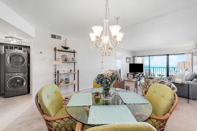 a dining room with furniture a chandelier and window