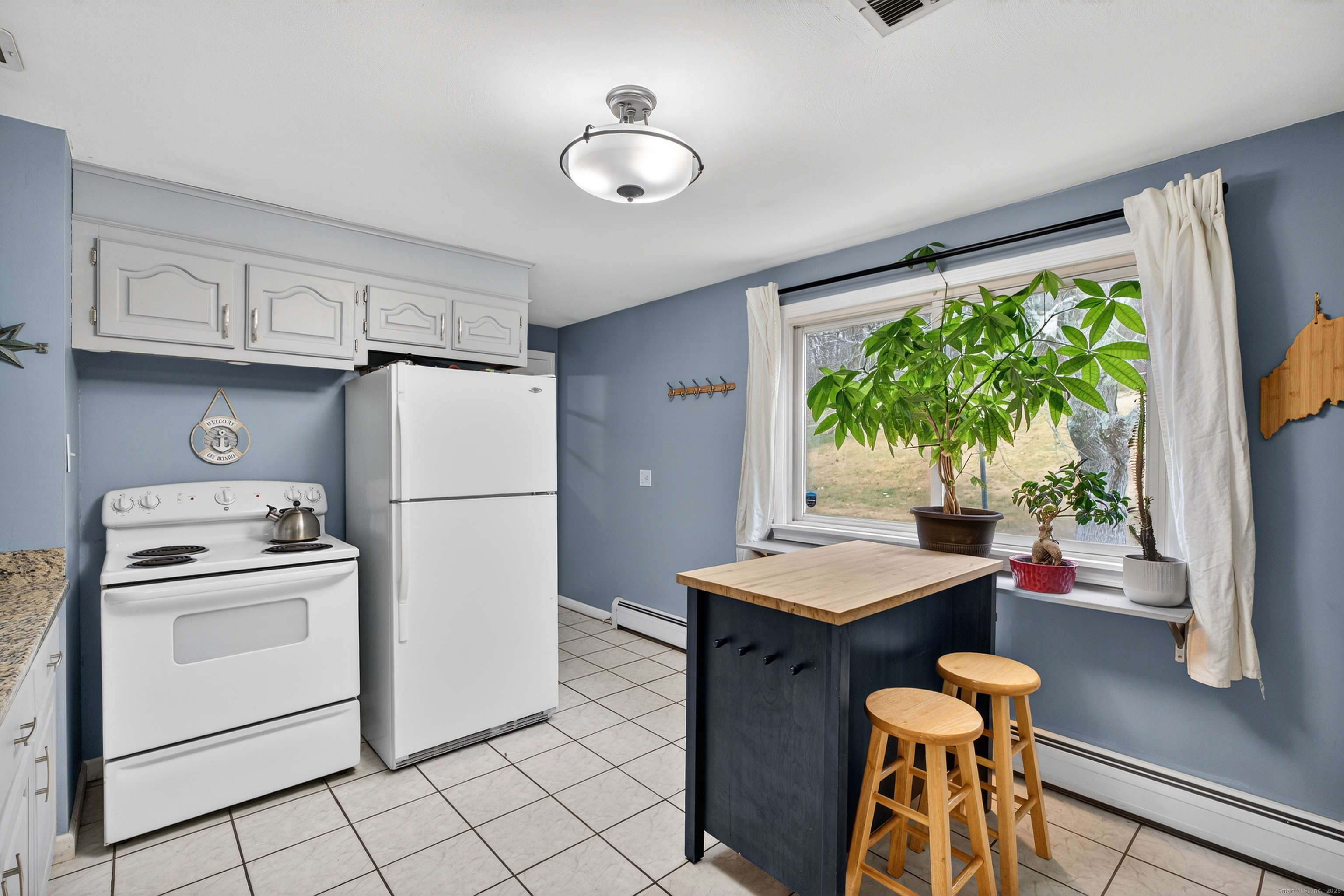 91 Highview Terrace Middletown, CT 06457 - Photo 16 of 39 a kitchen with stainless steel appliances granite countertop a refrigerator sink stove and white cabinets
