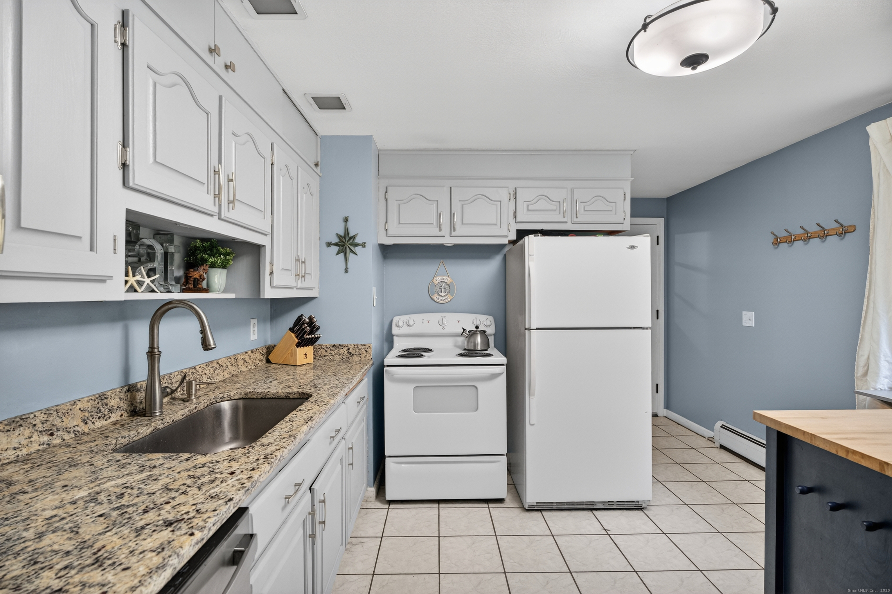 91 Highview Terrace Middletown, CT 06457 - Photo 22 of 39 a kitchen with a sink a stove a refrigerator and cabinets