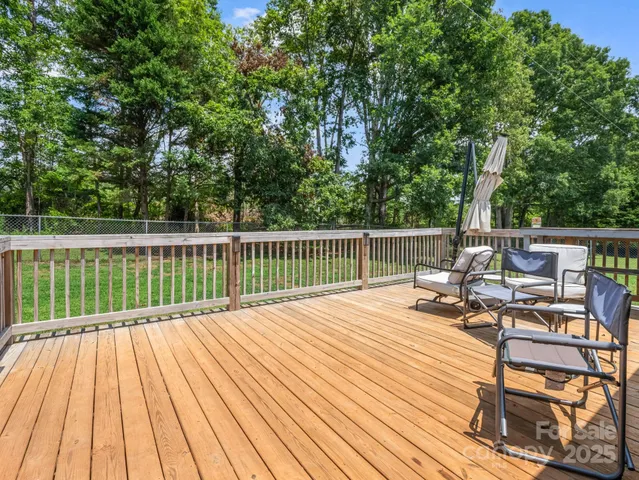 a view of balcony with wooden floor and outdoor seating