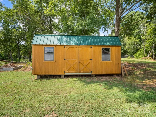a view of a backyard with a small cabin