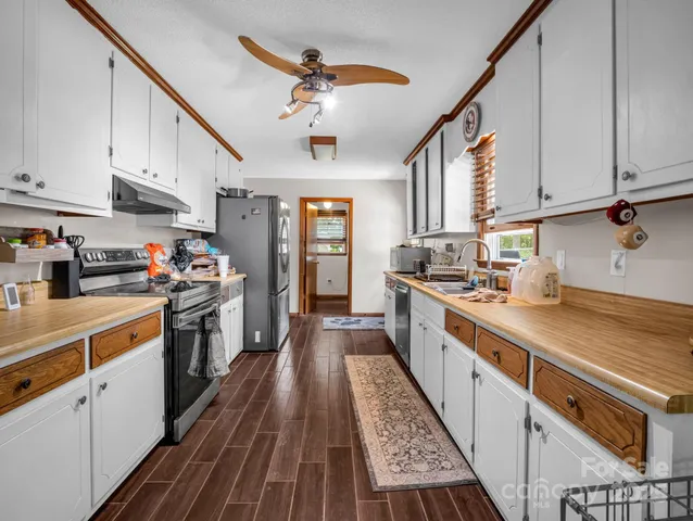 a kitchen with granite countertop lots of counter top space and stainless steel appliances