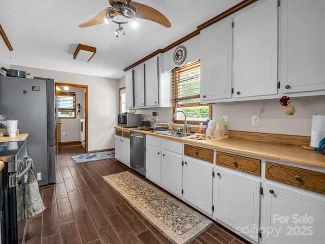 a kitchen with cabinets appliances and a window
