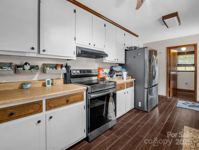 a kitchen with stainless steel appliances a stove a refrigerator and cabinets