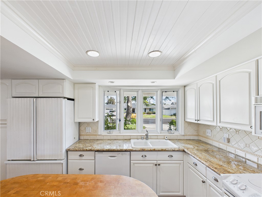 2857 Ellesmere Avenue Costa Mesa, CA 92626 - Photo 13 of 45 a kitchen with a sink window and cabinets