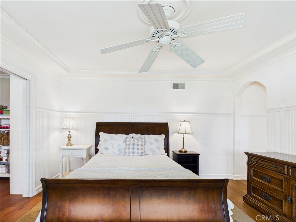 2857 Ellesmere Avenue Costa Mesa, CA 92626 - Photo 17 of 45 a bedroom with a bed and wooden floor